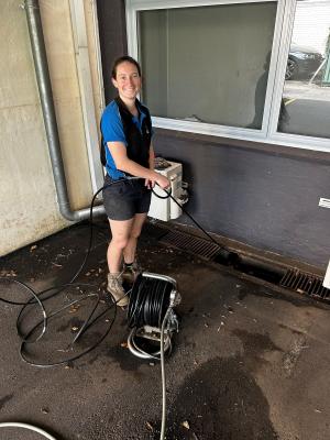 Female plumbing apprentice putting her skills into action on major infrastructure project