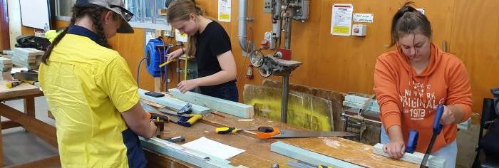 Female apprentices nail carpentry trade​​​​​​​
